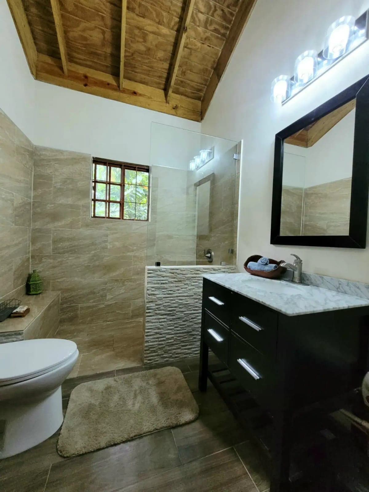 Modern bathroom under a timber ceiling